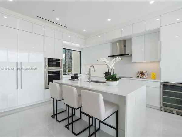 a kitchen with stainless steel appliances kitchen island granite countertop a sink and cabinets