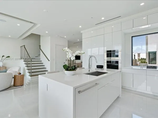 a kitchen with stainless steel appliances kitchen island granite countertop a sink and cabinets