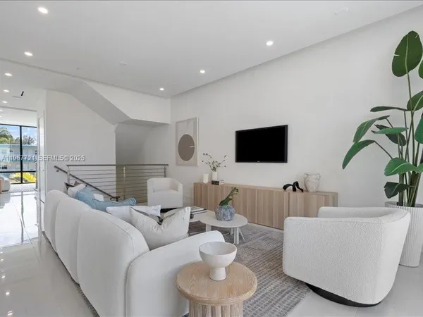 a living room with furniture a large window with outer view