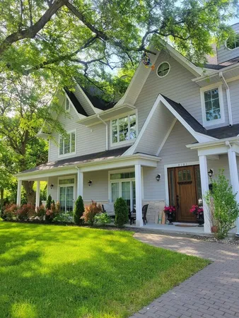 a front view of a house with a garden and plants