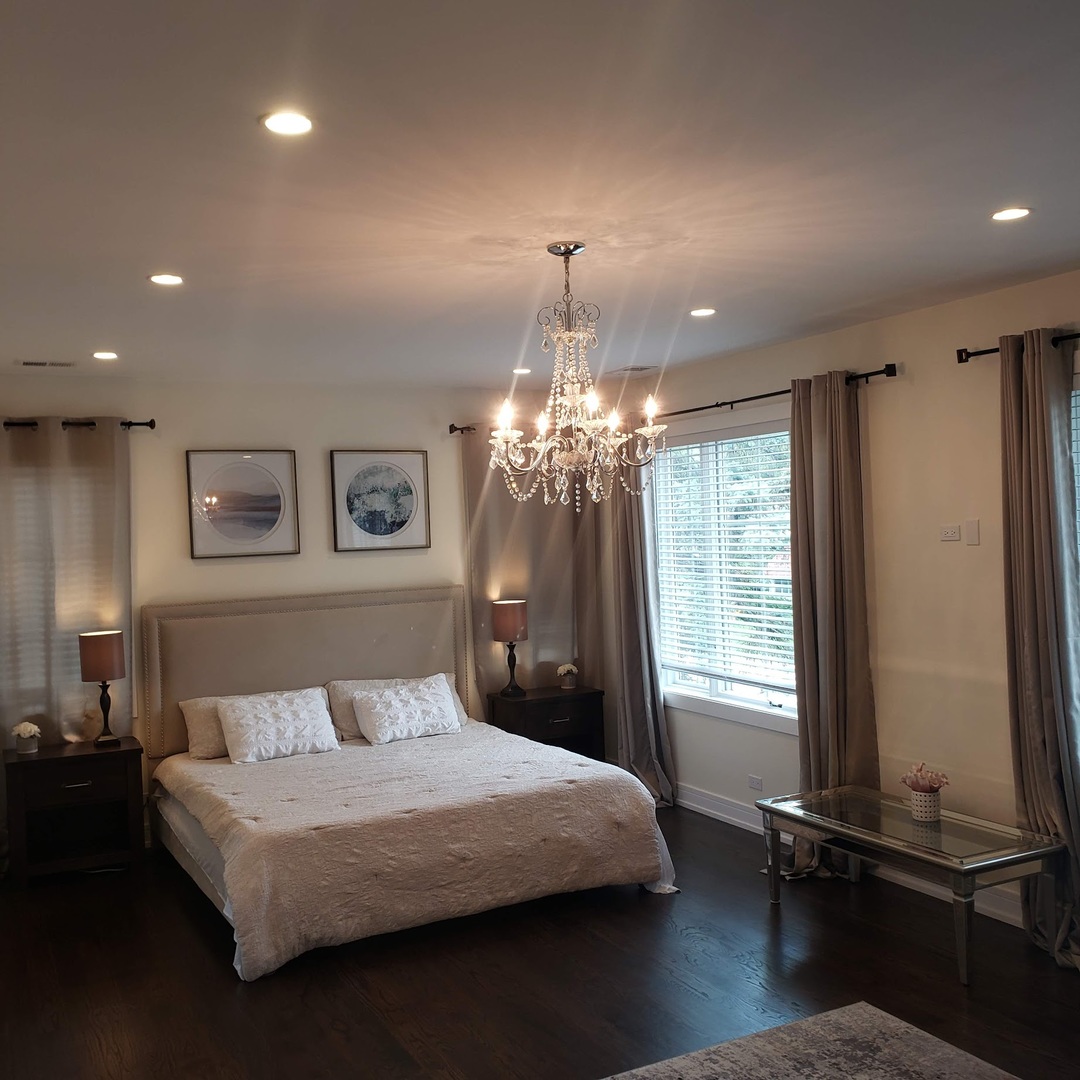 3101 Sprucewood Road Wilmette, IL 60091 - Photo 4 of 10 a bedroom with a bed and a chandelier