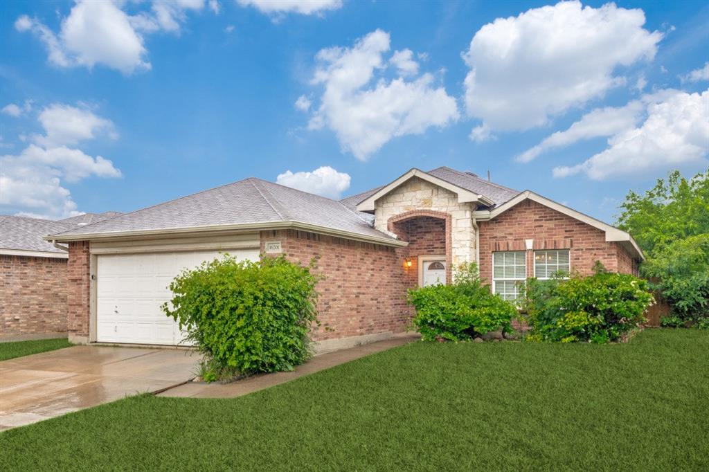 16701 Windthorst Way Fort Worth, TX 76247 - Photo 1 of 12 a view of a white house with a yard and plants