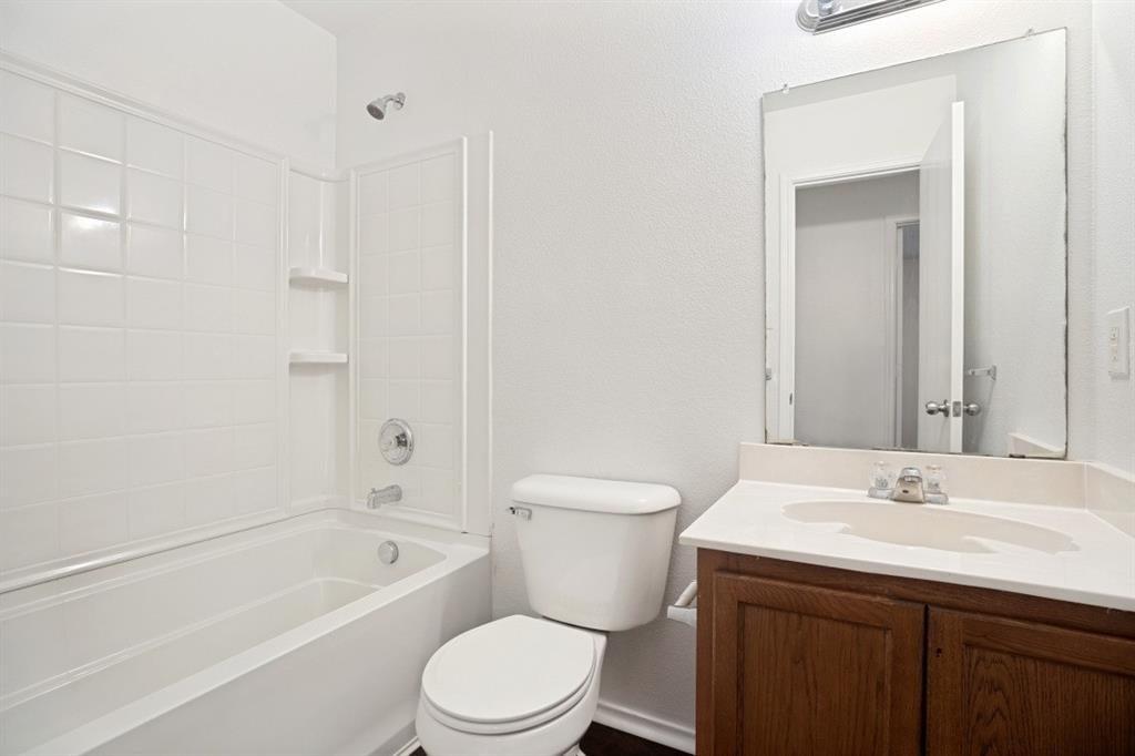 16701 Windthorst Way Fort Worth, TX 76247 - Photo 12 of 12 a bathroom with a sink a toilet and shower