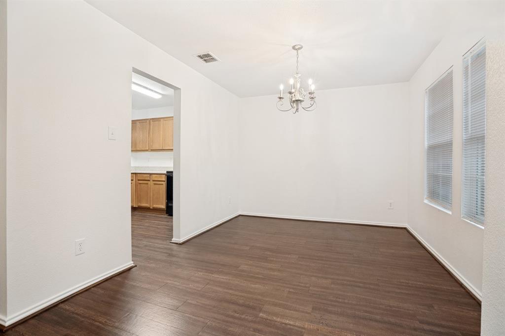 16701 Windthorst Way Fort Worth, TX 76247 - Photo 4 of 12 wooden floor in an empty room with a window