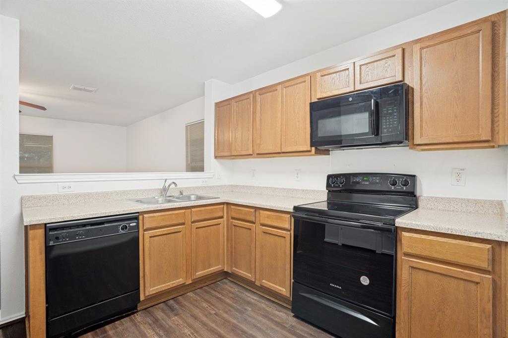 16701 Windthorst Way Fort Worth, TX 76247 - Photo 6 of 12 a kitchen with a sink stove and microwave