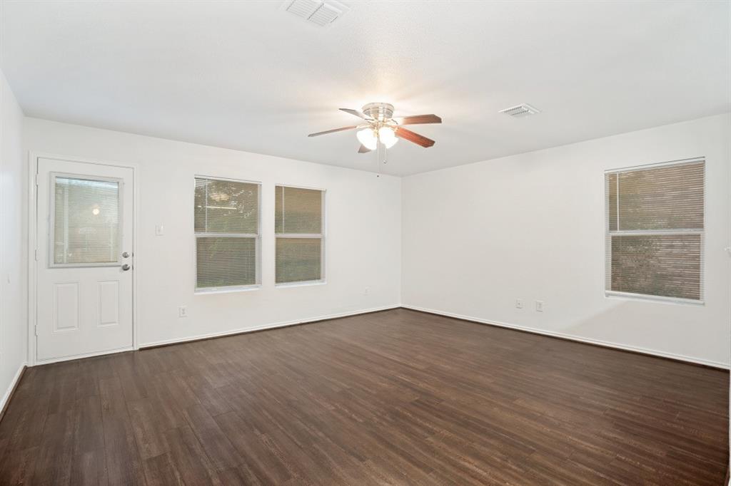 16701 Windthorst Way Fort Worth, TX 76247 - Photo 7 of 12 a view of empty room with wooden floor and fan
