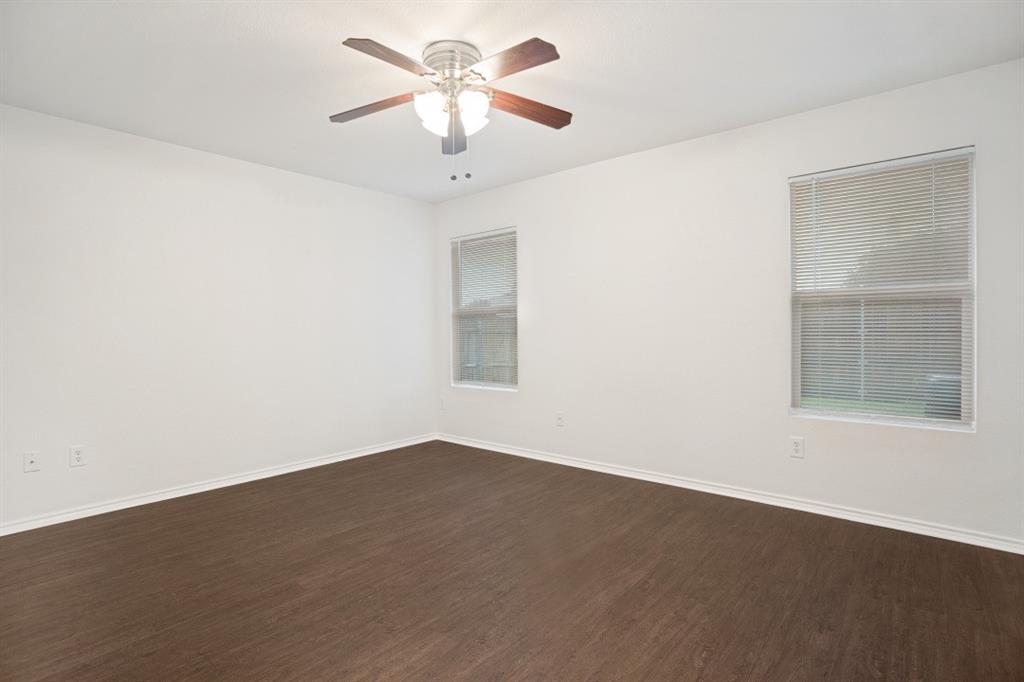 16701 Windthorst Way Fort Worth, TX 76247 - Photo 8 of 12 an empty room with a window and a fan