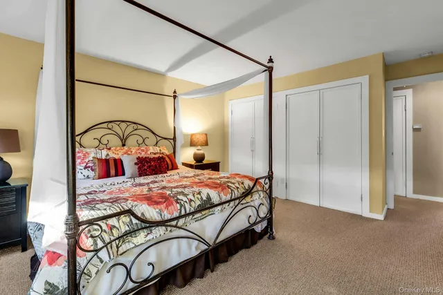 a bedroom with a bed and a mirror