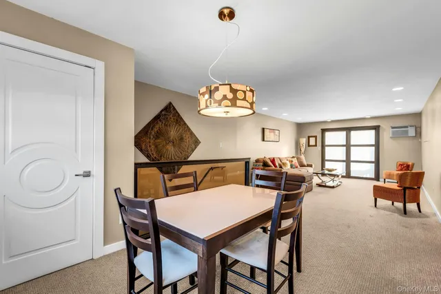 a dining room with furniture a rug and a window