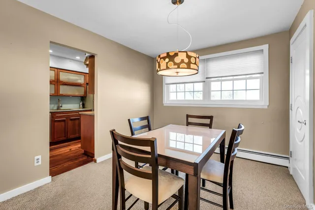 a view of a dining room with furniture and window