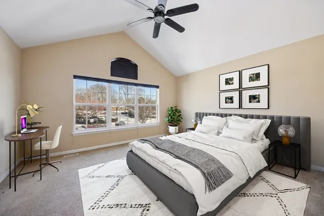 a bedroom with a large bed and a window