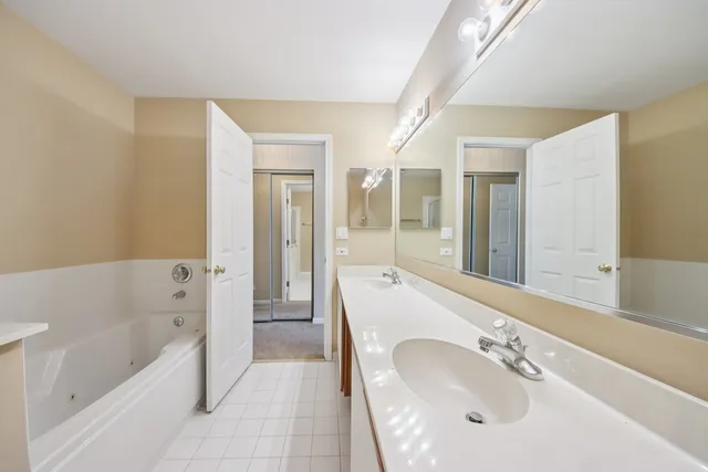 a bathroom with a bathtub shower and a sink