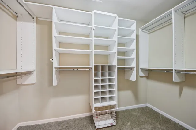 a view of walk in closet with empty racks