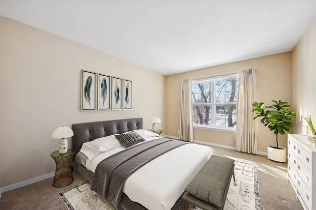 a bedroom with a bed and a potted plant