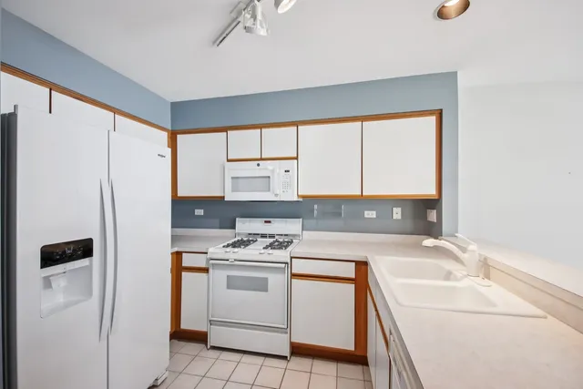 a kitchen with a stove a sink and a refrigerator
