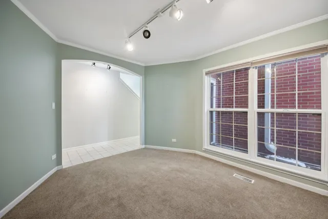 an empty room with windows and closet