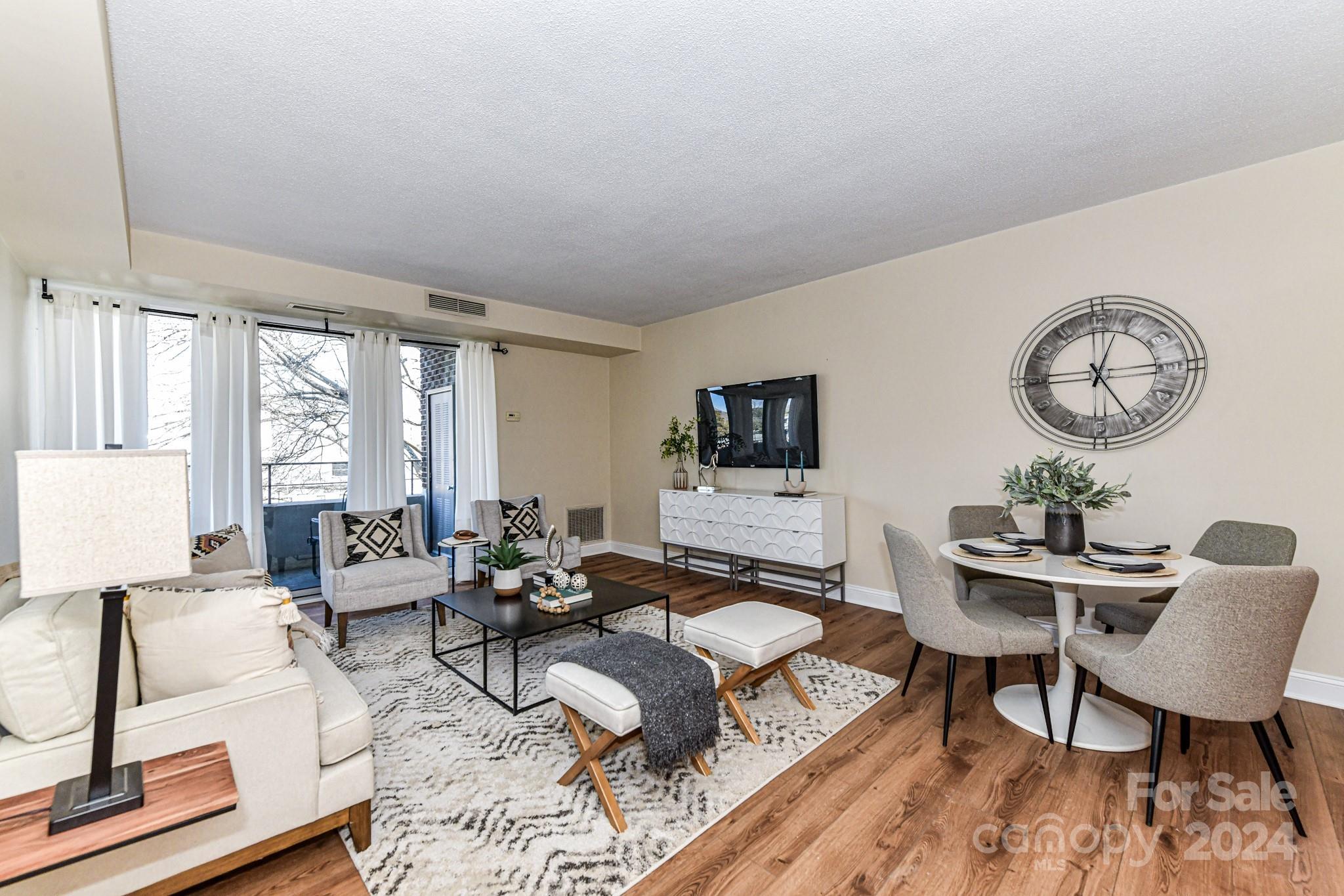 1300 Reece Road, Unit 415 Charlotte, NC 28209 - Photo 11 of 32 a living room with furniture and wooden floor