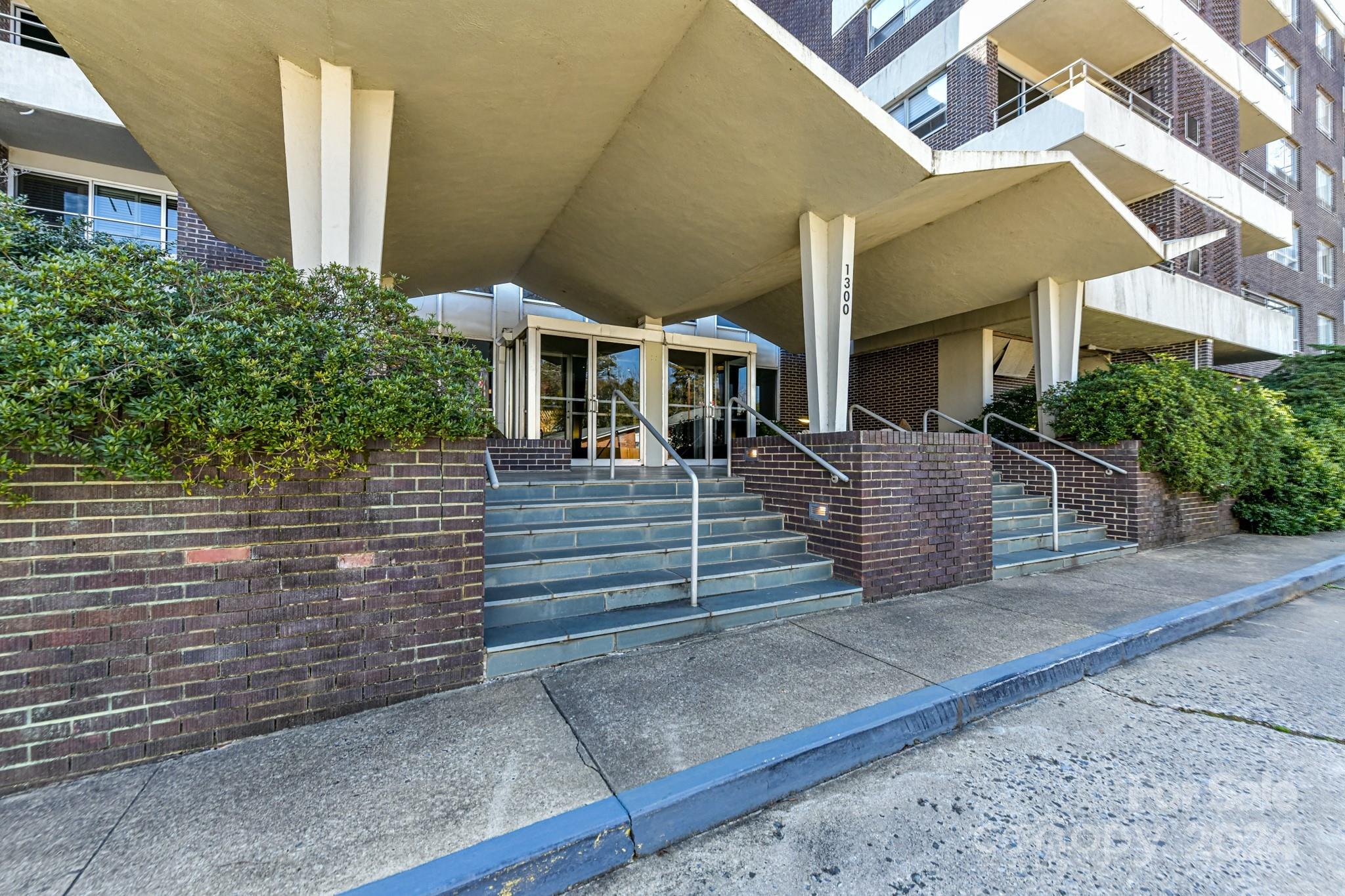1300 Reece Road, Unit 415 Charlotte, NC 28209 - Photo 2 of 32 a view of a brick house with many windows