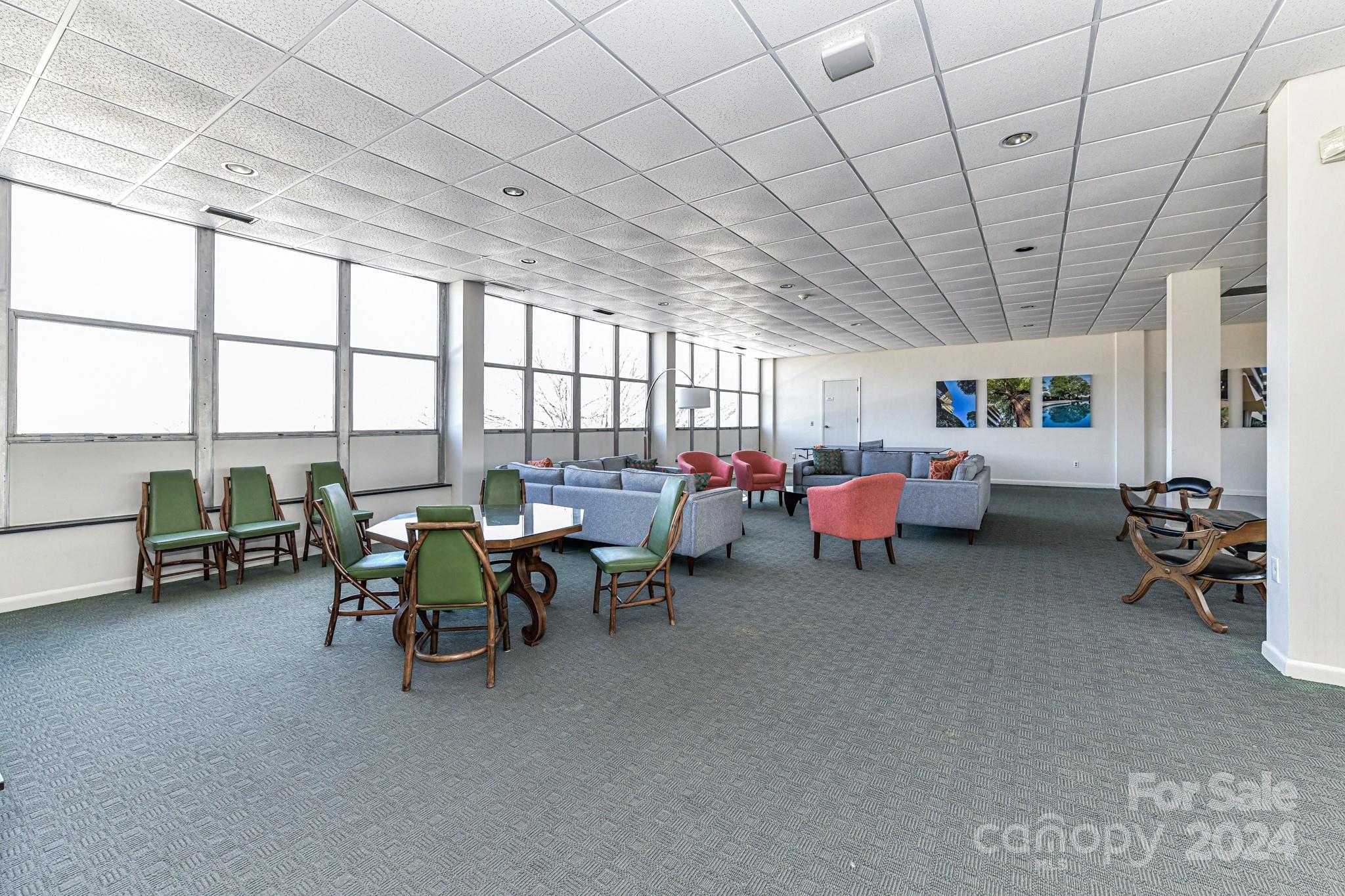 1300 Reece Road, Unit 415 Charlotte, NC 28209 - Photo 29 of 32 a living room with lots of furniture and a chandelier