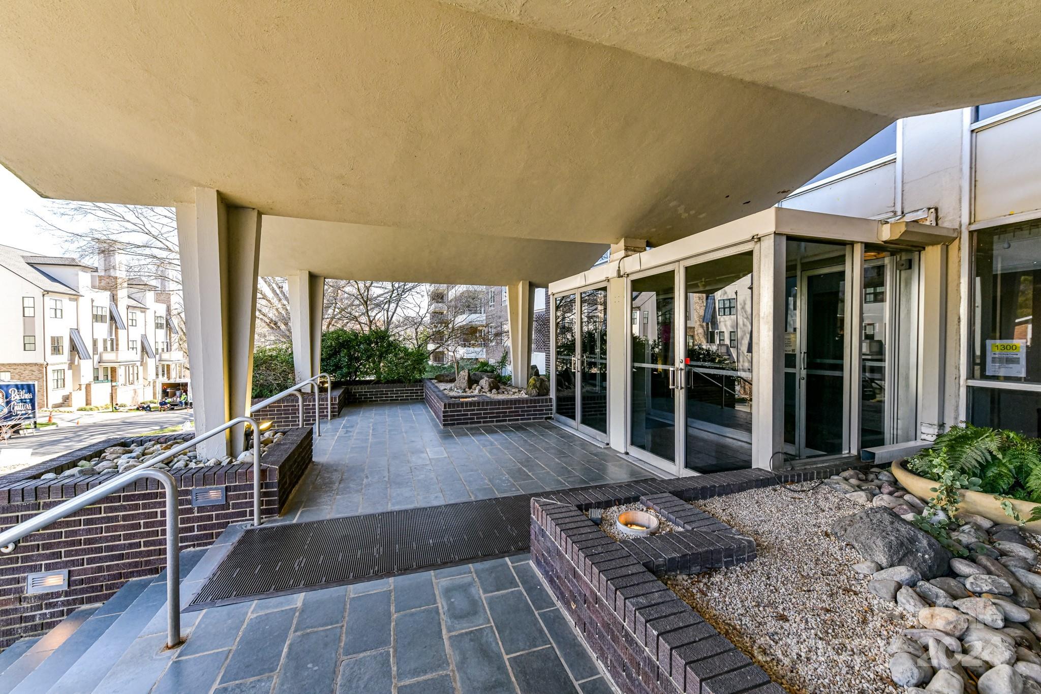 1300 Reece Road, Unit 415 Charlotte, NC 28209 - Photo 3 of 32 a view of a patio with couches table and chairs and potted plants