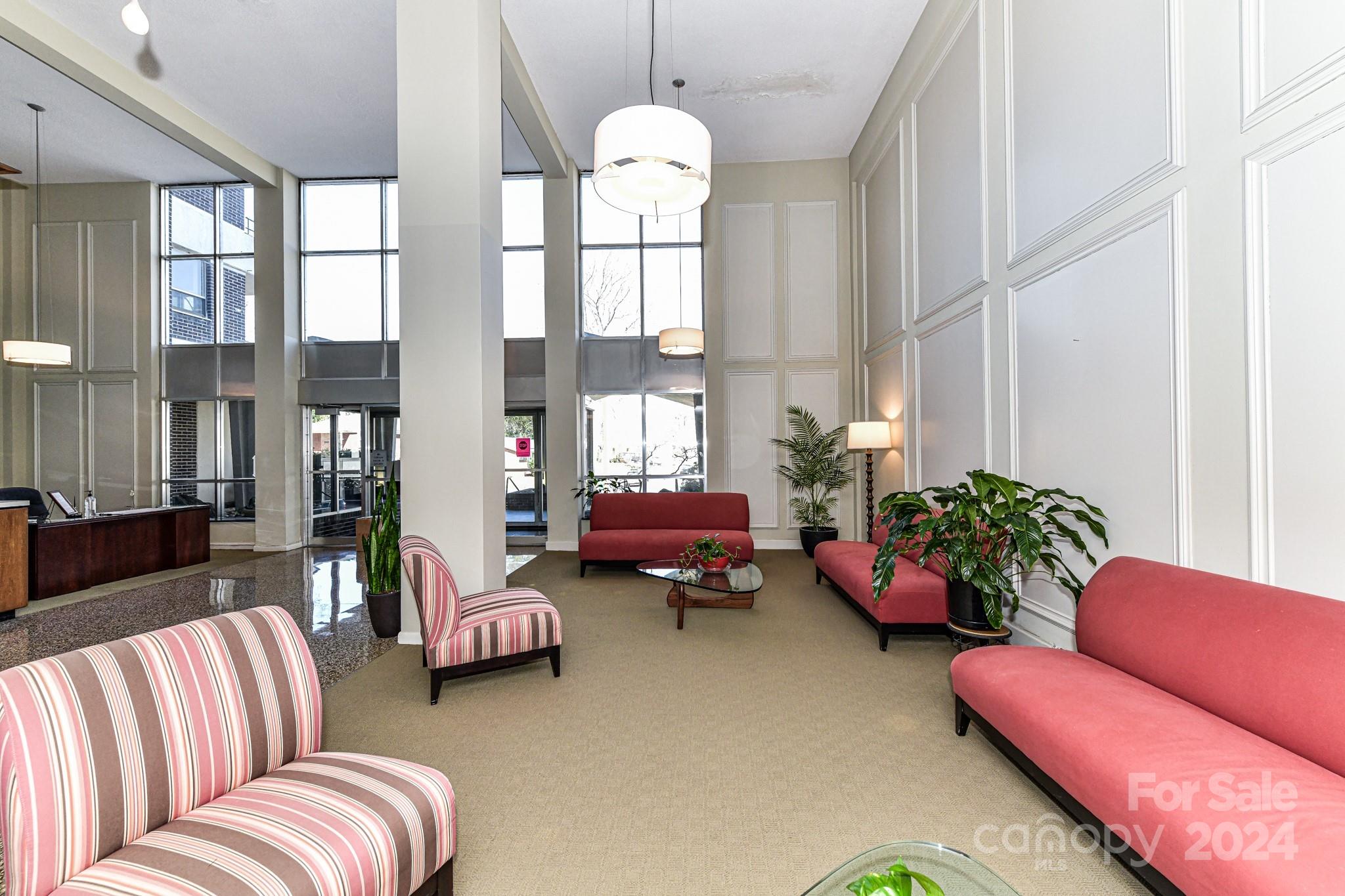 1300 Reece Road, Unit 415 Charlotte, NC 28209 - Photo 5 of 32 a living room with furniture flowers and a chandelier