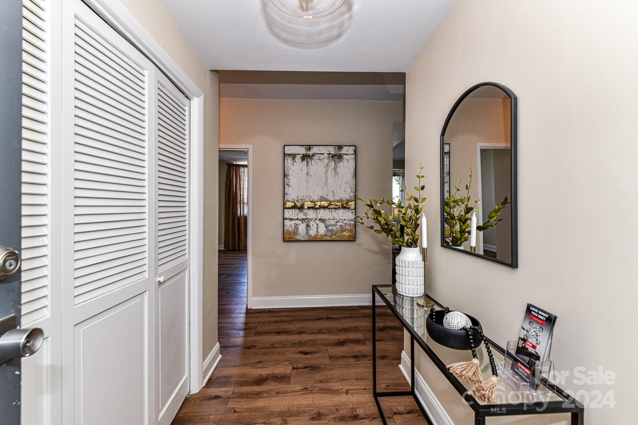 1300 Reece Road, Unit 415 Charlotte, NC 28209 - Photo 6 of 32 a view of a hallway with wooden floor and workspace