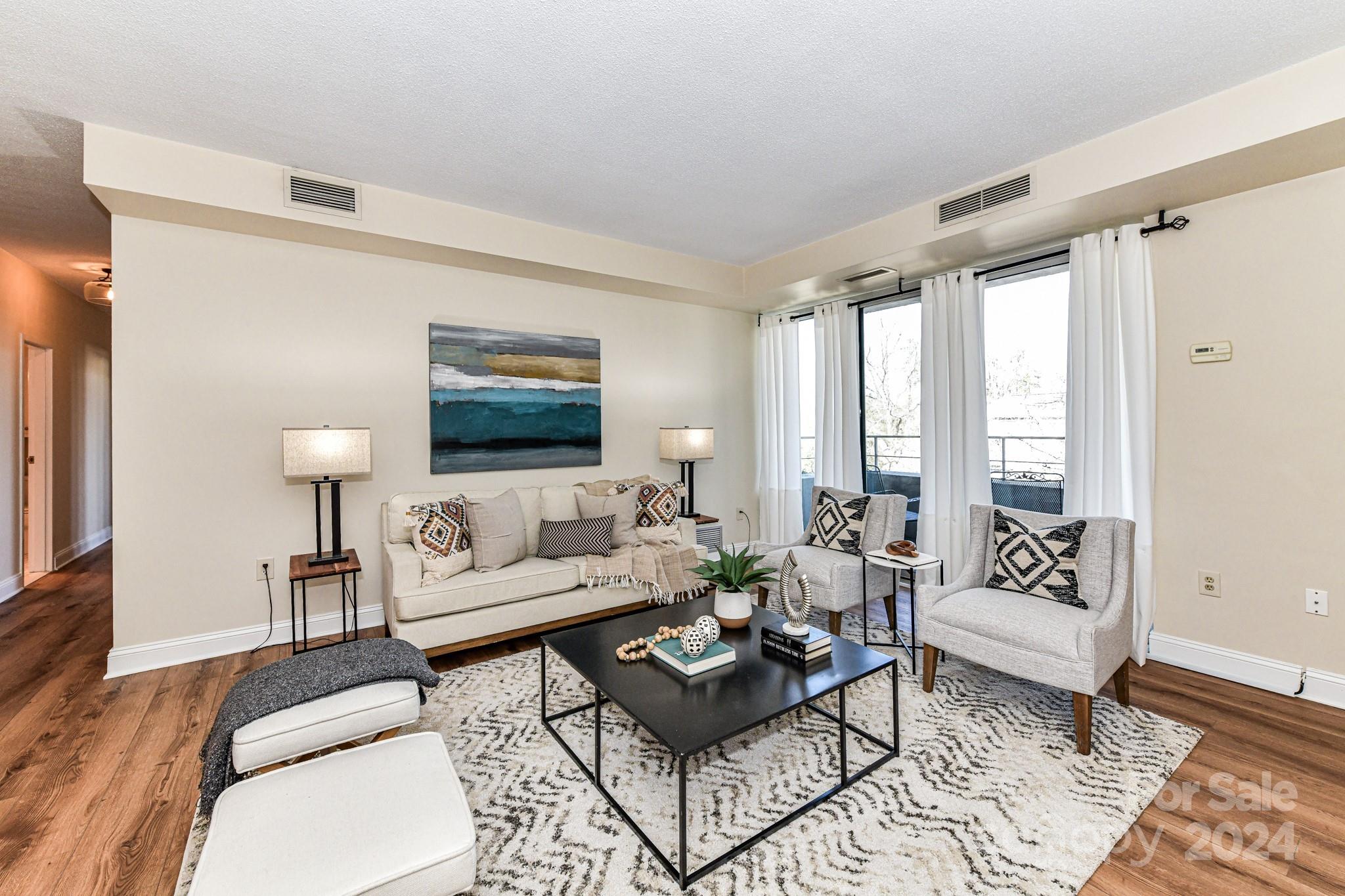1300 Reece Road, Unit 415 Charlotte, NC 28209 - Photo 9 of 32 a living room with furniture and a flat screen tv