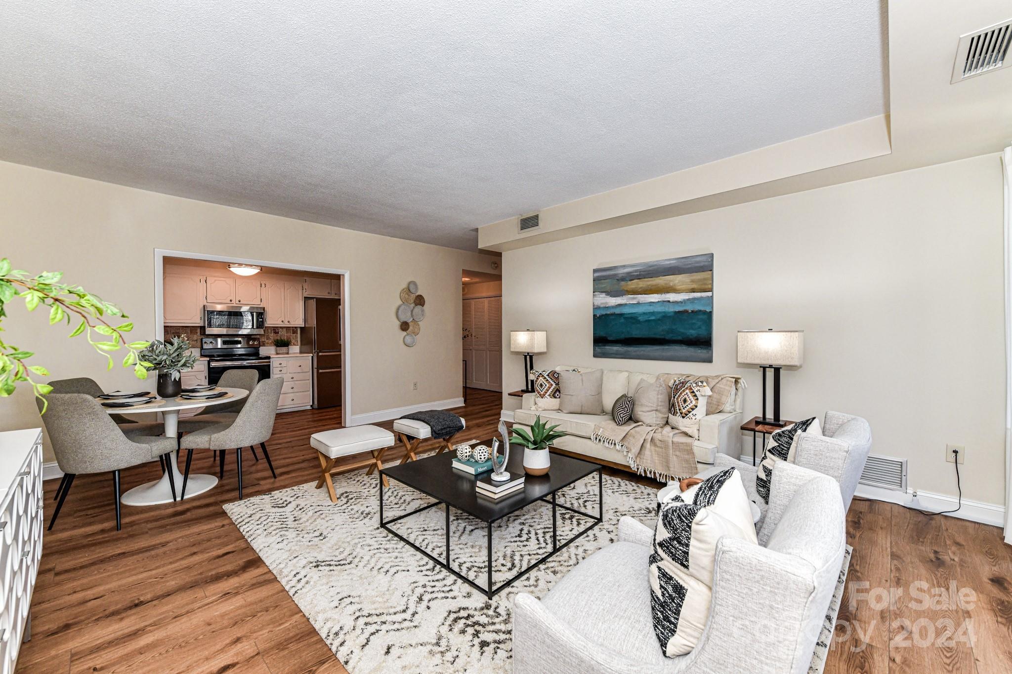 1300 Reece Road, Unit 415 Charlotte, NC 28209 - Photo 10 of 32 a living room with furniture and wooden floor