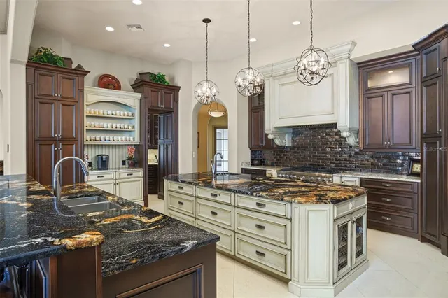 a kitchen with stainless steel appliances granite countertop a stove and a refrigerator