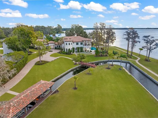 a view of a swimming pool with a bench and trees in the background