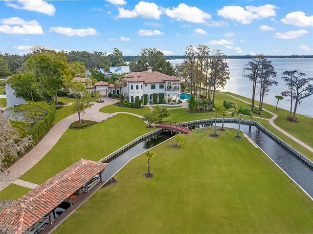 a view of a swimming pool with a bench and trees in the background