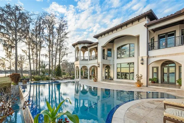 a large kitchen with lots of counter space and wooden floor
