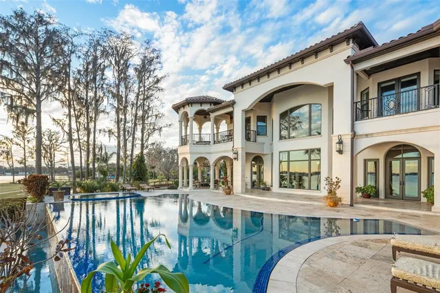 a large kitchen with lots of counter space and wooden floor