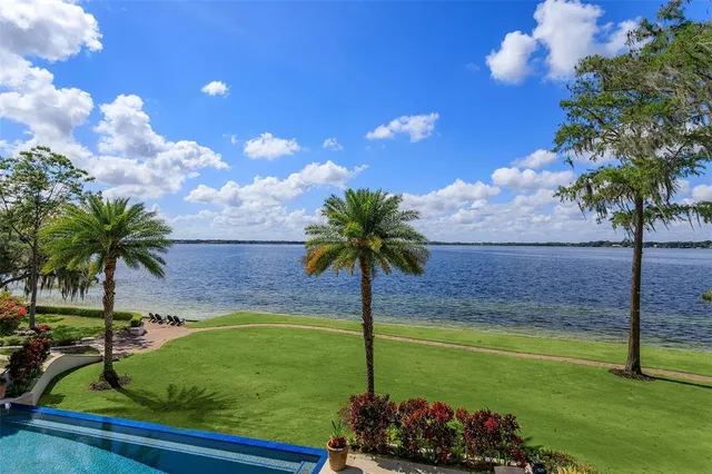 a spacious bedroom with a bed and a chandelier