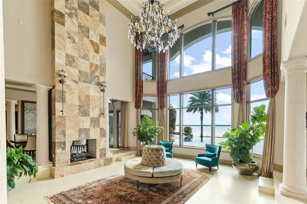 a living room with furniture and a chandelier