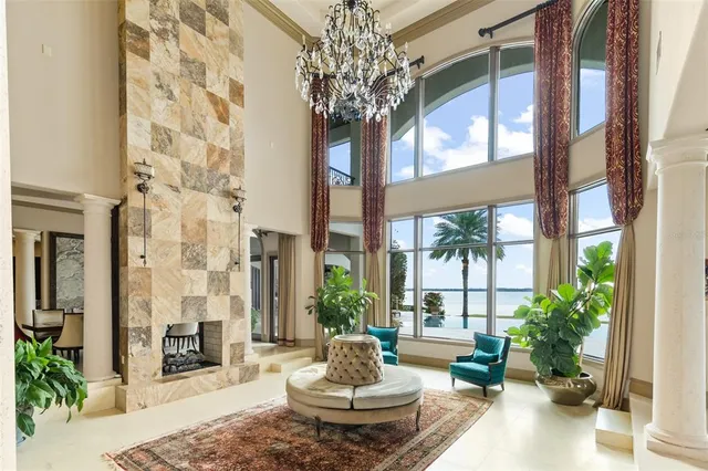 a living room with furniture and a chandelier