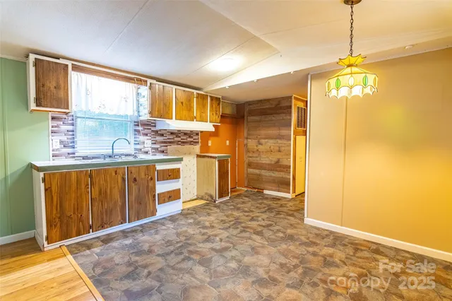 a view of a kitchen with a sink and a refrigerator