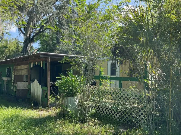 a backyard of a house with lots of green space and fountain