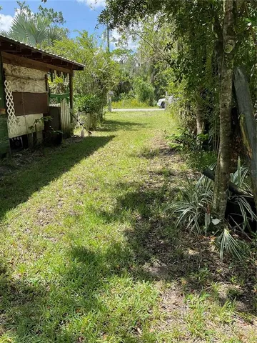 a backyard of a house with lots of green space