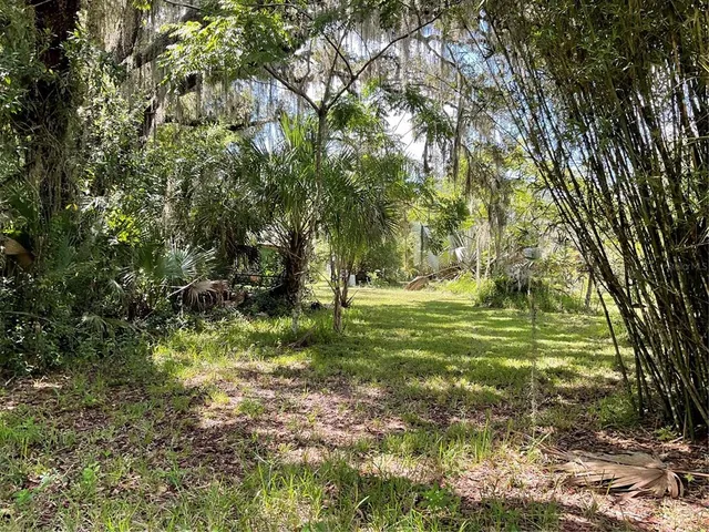 a swimming pool with trees in the background