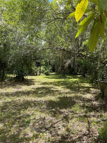 a backyard of a house with yard and outdoor seating