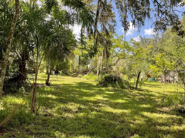 a swimming pool with trees in the background