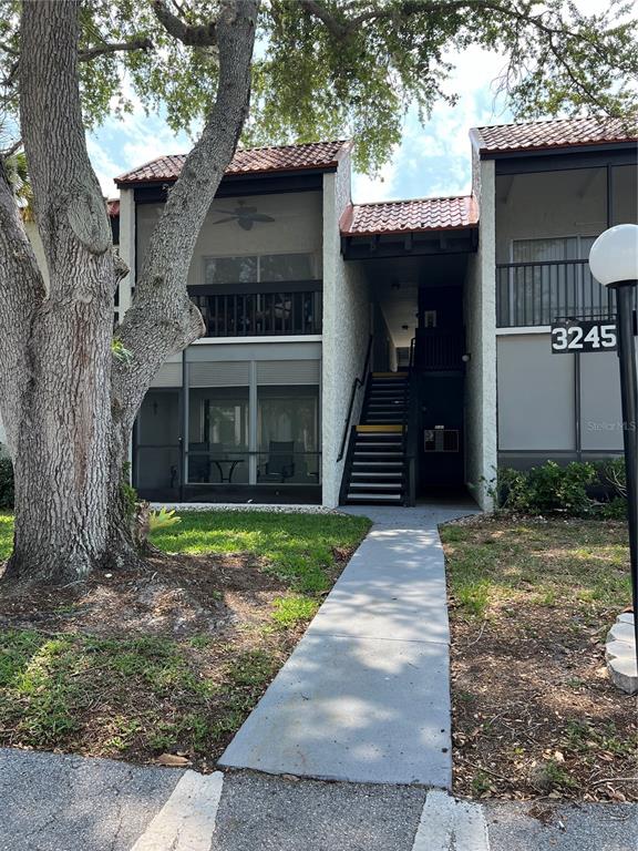 3245 South Beneva Road, Unit 203 Sarasota, FL 34232 - Photo 1 of 1 a front view of a house with a yard
