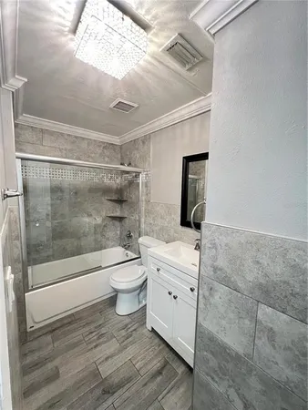 a bathroom with a bathtub shower sink mirror and toilet