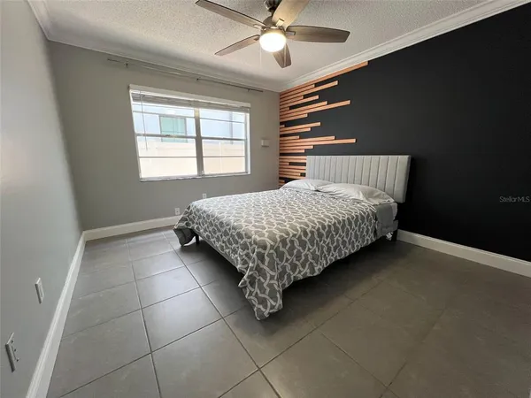 a bed sitting in a bedroom next to a window