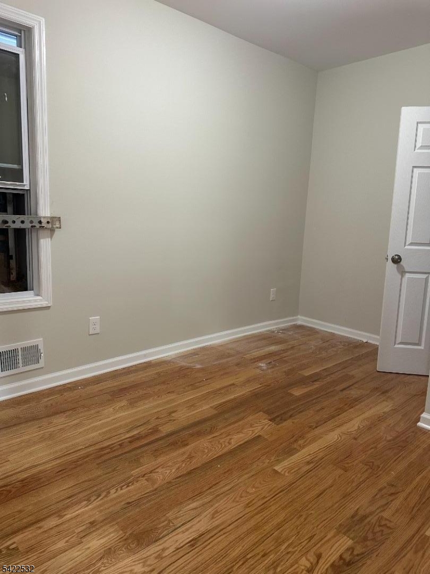 68 Arch Street Paterson, NJ 07522 - Photo 5 of 6 a view of a room with wooden floor and bathroom