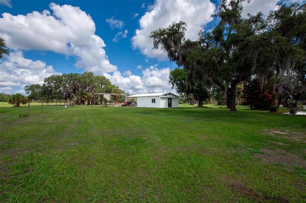 1635 Southwest Rodgers Avenue Arcadia, FL 34266 - Photo 24 of 32 a view of a white house in a big yard with large trees