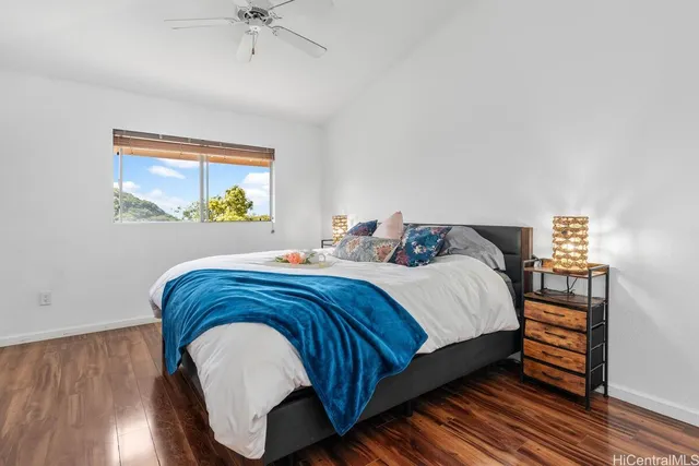 a bedroom with a bed and a painting on the wall