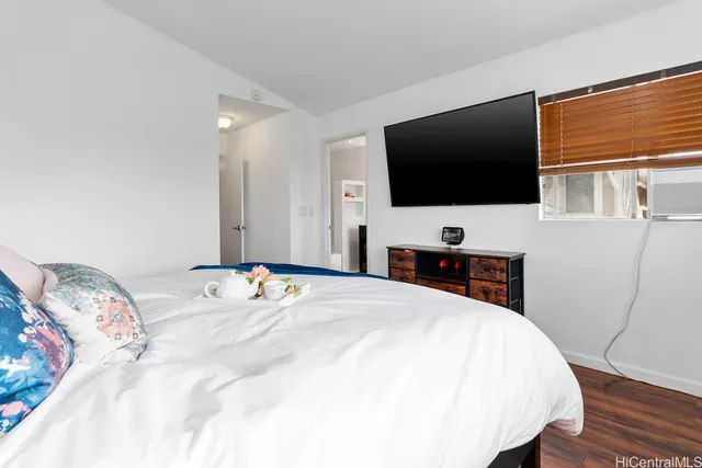 a bedroom with a bed and a flat screen tv