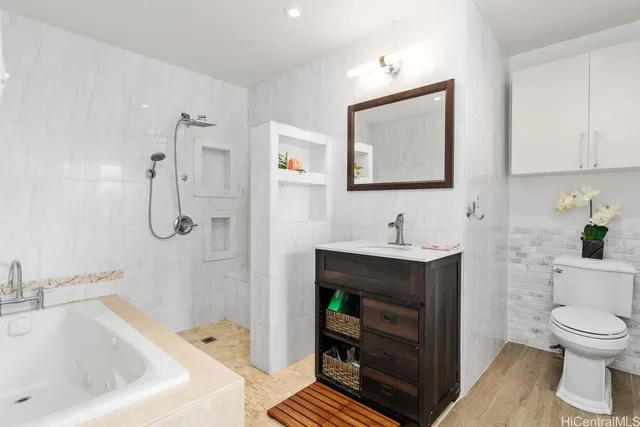 a bathroom with a sink a toilet and shower